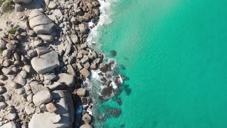 Tranquil-aerial-tropical-paradise-with-turquoise-water-waves-crashing-on-rocks