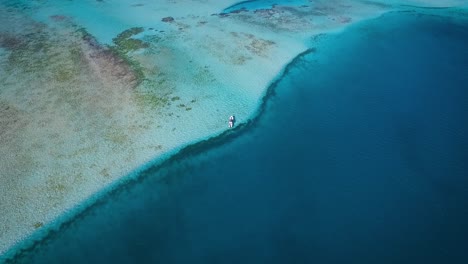 From-the-top-view-of-a-small-fishing-boat,-floating-in-the-blue-Caribbean-sea,-at-Los-Roques-Venezuela