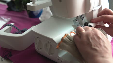 View-Of-Tailor-Using-Sewing-Machine-On-Table