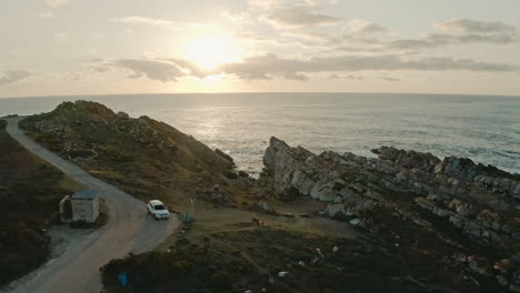 Flying-Towards-The-Rock-Formations-And-Cliffs-Near-The-Blue-Ocean-With-A-Beautiful-Sunset-On-The-Background-In-Vleesbaai,-Western-Cape,-South-Africa---aerial-drone-shot