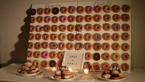 Variety-of-doughnuts-displayed-on-a-wall,-medium-shot