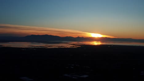 Gorgeous-aerial-drone-view-of-Utah-lake-during-a-golden-sunset-on-a-warm-fall-evening-in-Provo