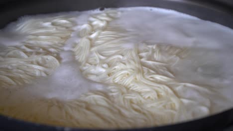 Closeup-Boiling-Korean-rice-noodle-guksu-in-a-big-pot