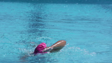 footage-of-a-female-swimmer-swimming-laps-in-an-outdoor-pool-using-the-freestyle-stroke-as-part-of-her-triathlon-training-plan