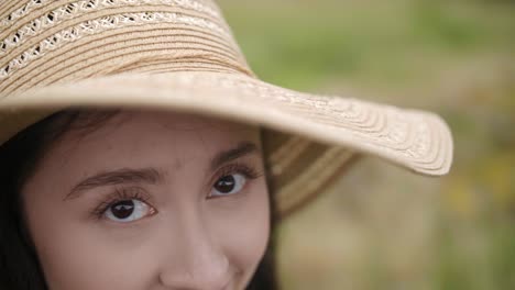 Close-Up-Pretty-Girl-with-Straw-Hat-Looks-Toward-the-camera-with-Beautiful-Eyes