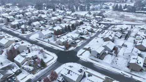 Wide-exterior-aerial-of-snow-covered-houses-in-suburban-America