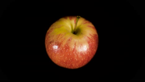 Close-Up-Shot-Of-Ripe-And-Juicy-Red-Apple-Isolated-On-Black-Background