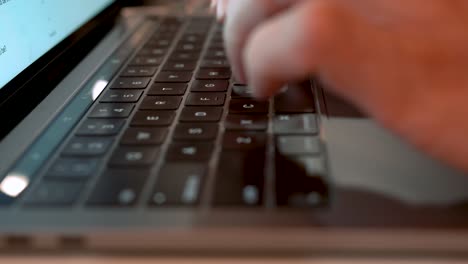 Man-typing-on-a-laptop-keyboard