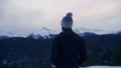 Young-Woman-on-Lookout-Watching-the-Snow-Mountain-Range
