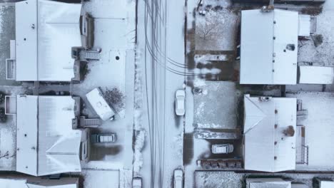 Top-down-aerial-view-of-a-snow-covered-neighborhood-in-suburban-America