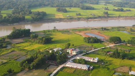 Aerial-Ascending-Shot-View-Over-Rural-Sylhet-Countryside-With-Surma-River-In-Background