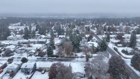 Wide-establishing-drone-shot-of-suburban-neighborhoods-covered-in-snowfall