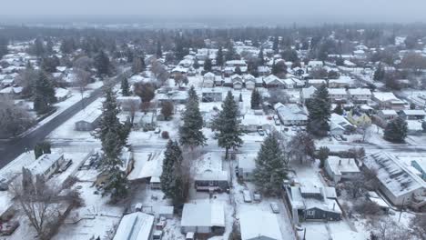 Side-scrolling-aerial-shot-of-neighborhoods-covered-with-a-fresh-blanket-of-snow
