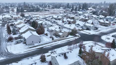Drone-shot-of-a-neighborhood-blanketed-with-snow