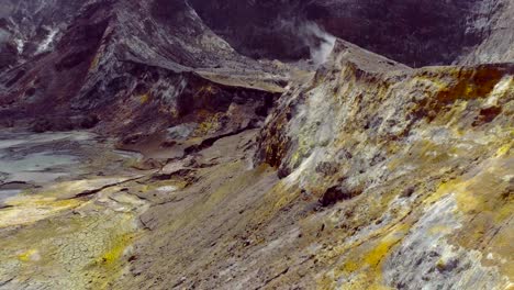 Crater-slope-colored-yellow-from-sulfur-mineral,-White-Island,-aerial