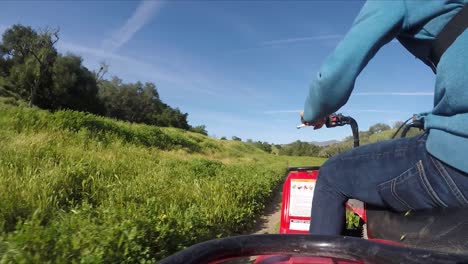 GoPro-Shot-of-ATV-Timelapse-Riding-on-Dirt-Road-in-California-Green-Fields