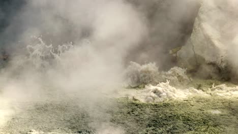 Toxic-geothermal-sulfur-mud-pool-boiling-water-and-emitting-steam