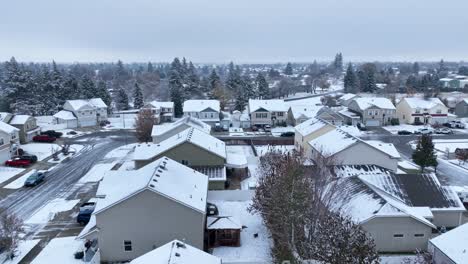 Drone-shot-of-houses-covered-in-snow