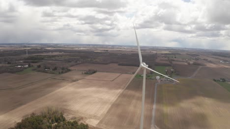 Drone-flying-past-blades-of-wind-power-propeller-not-spinning