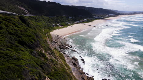 Picturesque-Wilderness-beach-with-rolling-waves-in-Garden-Route---aerial