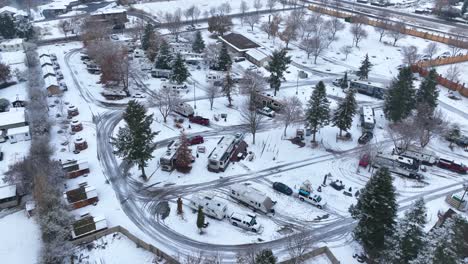 Rising-aerial-view-of-an-RV-Park-covered-in-snow