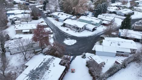 Drone-shot-of-a-mobile-home-park-covered-in-snow-from-a-winter-storm