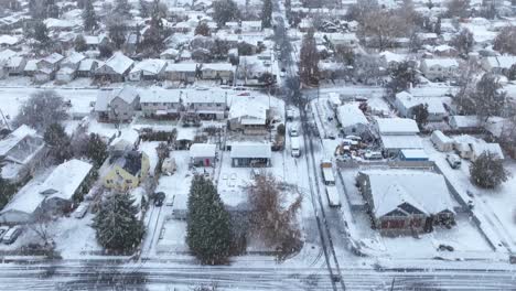 Drone-shot-of-a-Spokane-neighborhood-covered-in-snow-with-snowflakes-actively-falling