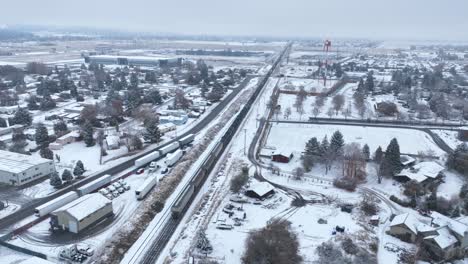 Aerial-view-of-a-train-traveling-through-a-snow-covered-landscape