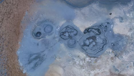 Spectacular-drone-shot-of-geothermal-mud-pool-in-blue-color-named-Hverir,Iceland