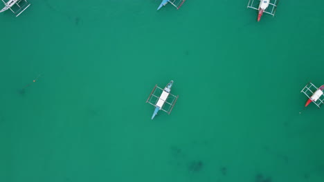 Top-view-drone-shot-of-boats-anchored-near-a-pier-dock
