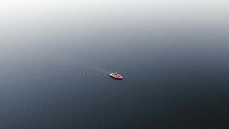 Slow-moving-red-boat-in-the-ocean