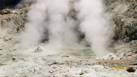 Geothermal-hot-pools-with-clouds-of-white-smoke-on-active-volcano