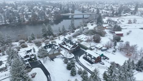 Aerial-view-of-waterfront-estates-covered-in-snow-on-the-Spokane-River
