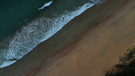 Drone-shot-of-waves-on-tropical-beach-in-El-nido,-Palawan