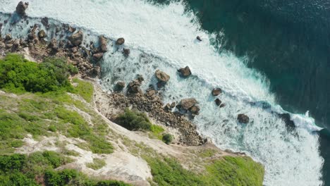 Luftbild-Von-Oben-Nach-Unten-Auf-Eine-Felsige-Küste-Mit-Weißen,-Schäumenden-Wellen,-Die-In-Die-Küste-Stürzen