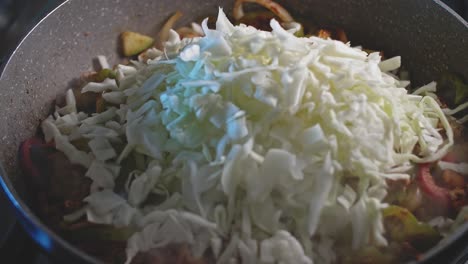 Cooking-ingredients-for-homemade-mexican-food-in-a-wok,-close-up-view
