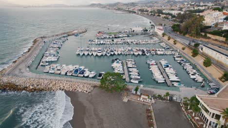Aerial-flyover-Marina-with-yacht-and-sailing-boat-parking-in-Malaga-City,Spain