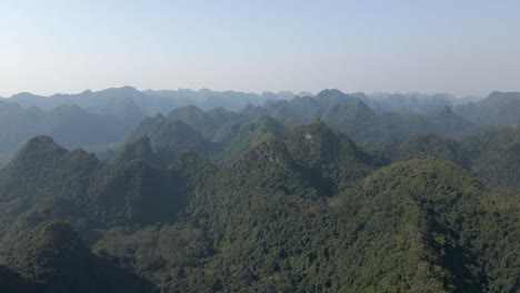 Steep-jagged-mountain-peaks,-covered-in-dense-green-jungle,-Vietnam