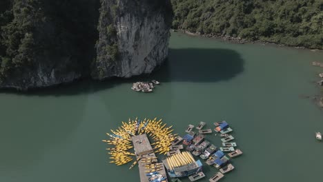 Rising-aerial-tilt:-Yellow-rental-kayaks-await-tourists-in-Vietnam