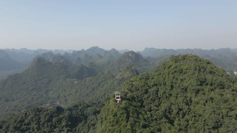 Aerial-retreats-from-tourism-viewing-tower-high-on-mountain-in-Vietnam