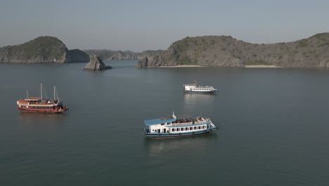 Tourists-lounge-atop-large-tour-boat-cruising-in-Ha-Long-Bay,-Vietnam