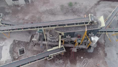 Industrial-machine-pulverizing-rock-into-different-types-of-gravel-and-sand-in-a-quarry---Aerial-view