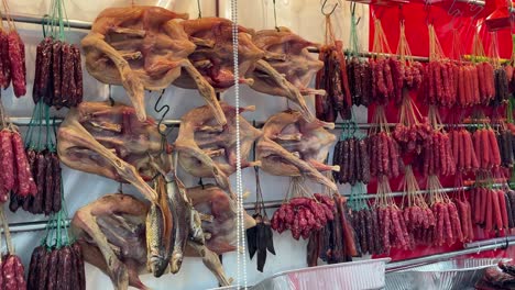 Array-of-Lap-Cheong,-also-known-as-red-Chinese-sausage-and-dried-waxed-duck-for-Chinese-New-Year-displayed-at-a-local-market