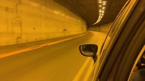 Driving-into-an-under-ground-tunnel-with-a-car,-recording-via-window-driver-side