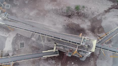 Industrial-machine-pulverizing-rock-into-different-types-of-gravel-and-sand-in-a-quarry---Aerial-view