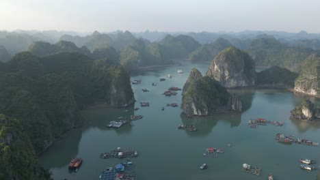 Misty-aerial-flyover-of-La-Han-Bay-floating-fishing-cages-in-Vietnam