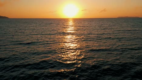 Drone-aerial-view-establishing-shot-over-beautiful-ocean-sunrise