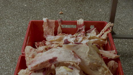 Slice-of-meat-being-thrown-into-crate