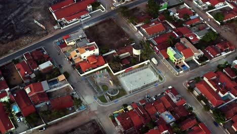 Aerial-bird's-eye-drone-shot-of-a-small-park-with-kids-playing-soccer-in-a-small-Brazilian-beach-town-in-Cabedelo-near-Joao-Pessoa-Brazil