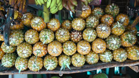 Pineapple-stack-at-grocery-on-tropical-marketplace-outdoor,Samana-peninsula,Dominican-republic